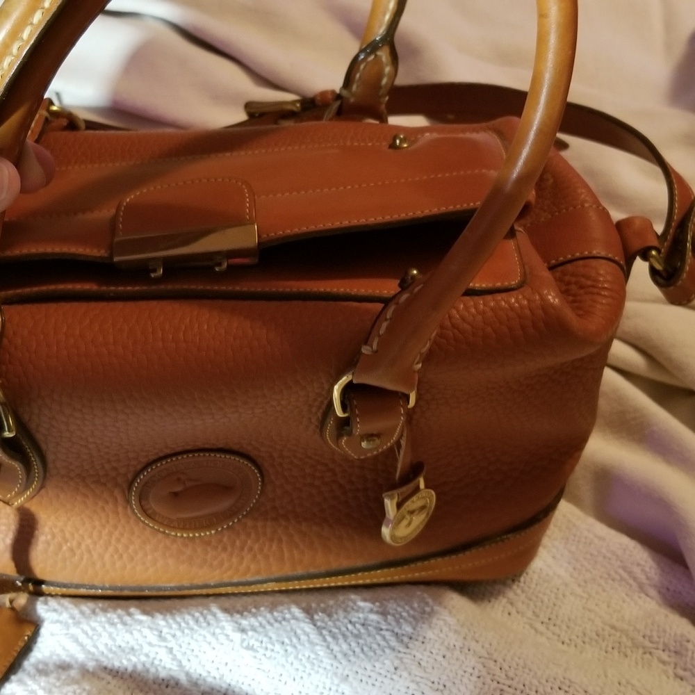 Dooney & Bourke famous locking, all weather bag